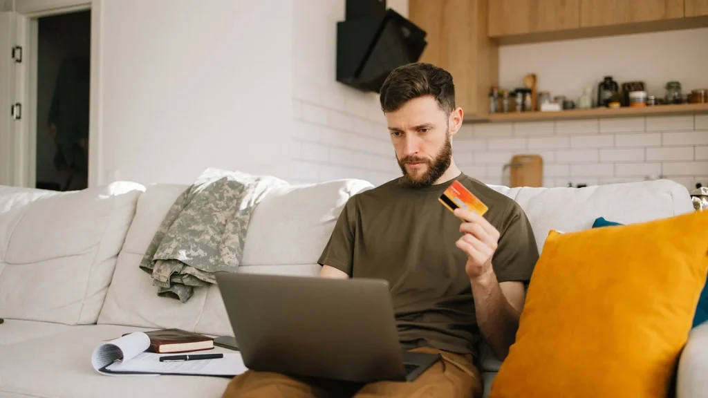 Person booking flight online on laptop