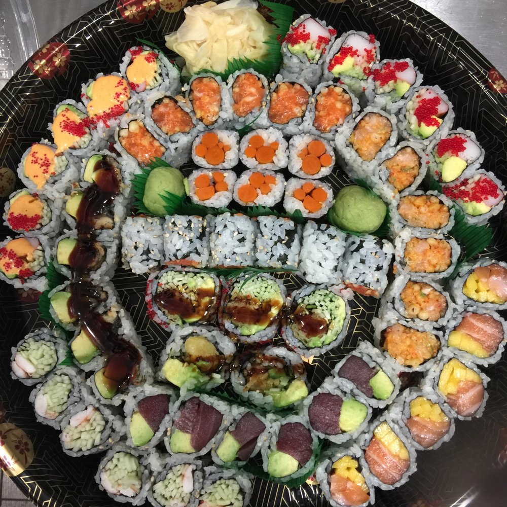 Affordable sushi lunch combo with multiple rolls, rice, and salad at a US restaurant.