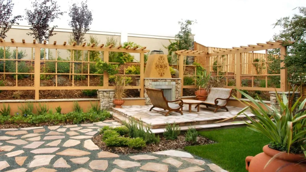 Backyard divided into zones using gravel, pavers, and planters.