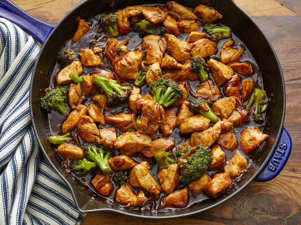 Healthy chicken and vegetable stir fry cooked in a skillet for two people