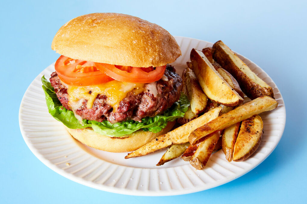Homemade cheeseburger with oven baked fries served for two