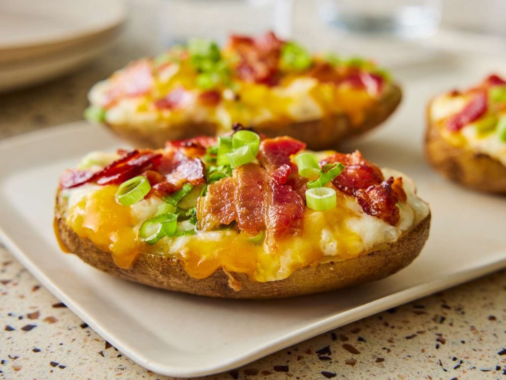 Loaded baked potatoes with cheese, bacon, and green onions for two