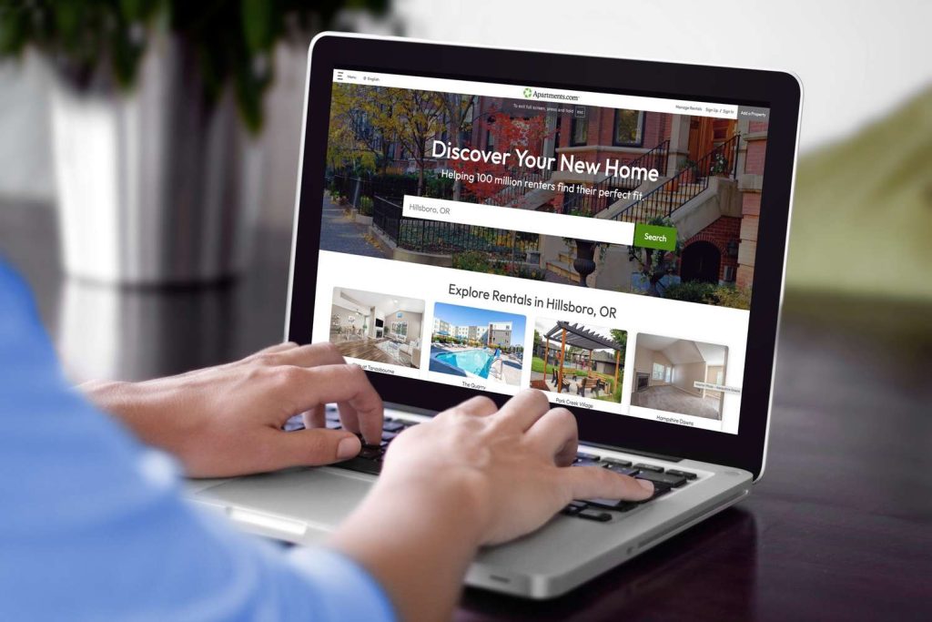 Person browsing apartment listings online while searching for affordable housing in the United States.
