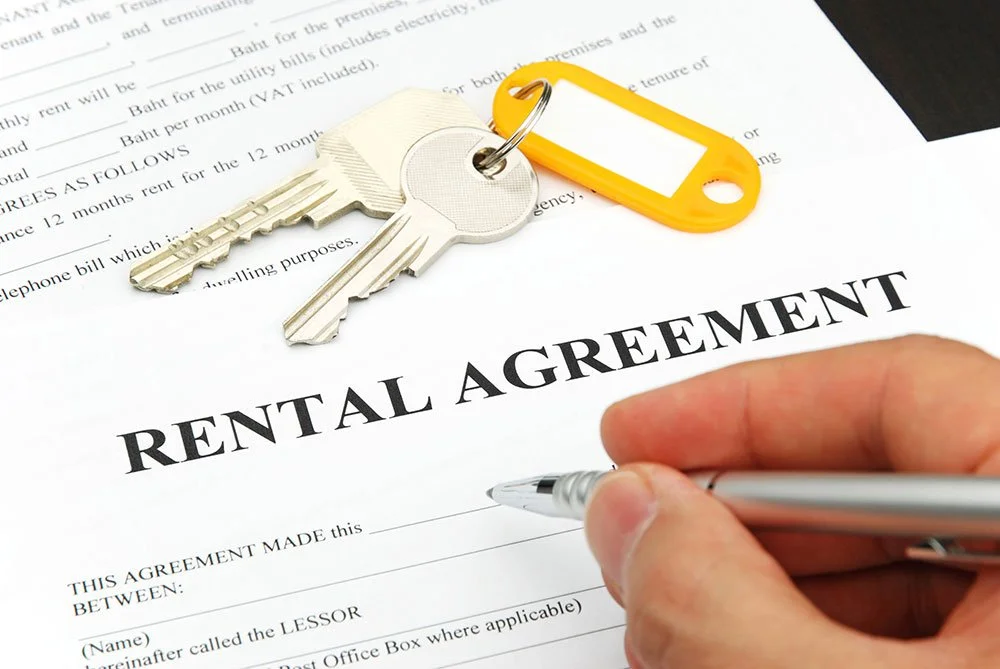 Renter or homebuyer carefully reviewing lease or property documents to avoid common housing mistakes in the United States.