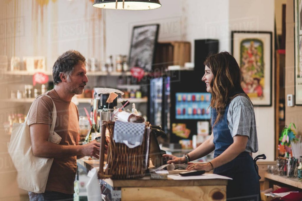 Shopper asking questions at a store counter about steap and cheap products
