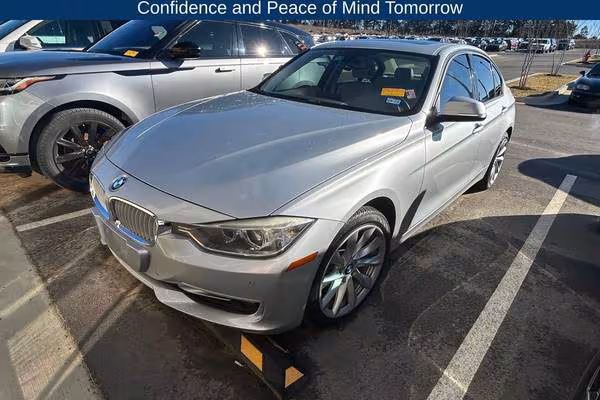 Used BMW 3 Series parked in a suburban American driveway