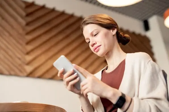 Shopper using a smartphone app to find steap and cheap deals