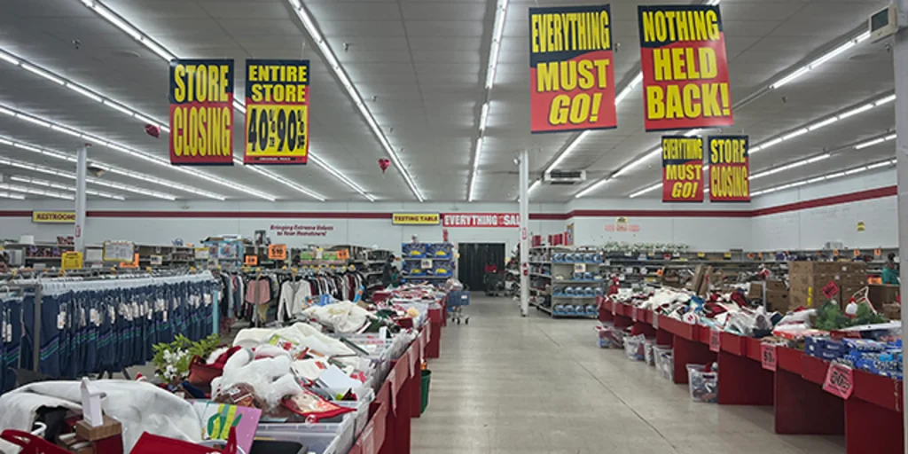 Empty shelves inside a closing Dirt Cheap store