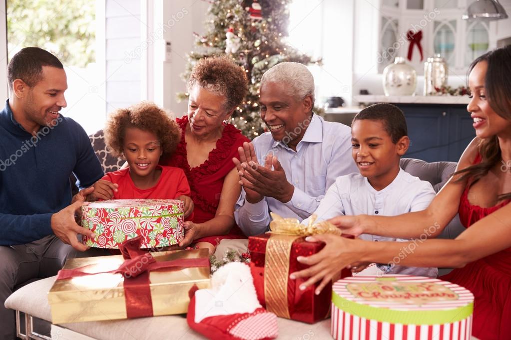 Family opening affordable Christmas gifts together in a warm holiday setting.
