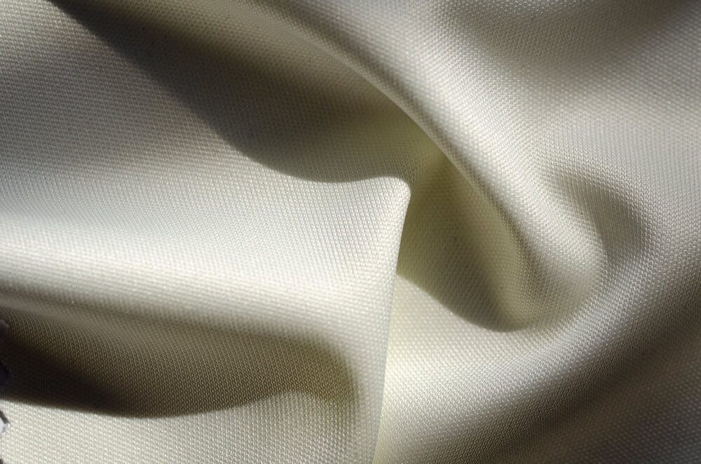 Close up view of fast fashion fabric and stitching quality used in low cost clothing