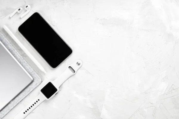 earbuds next to smartphone on desk