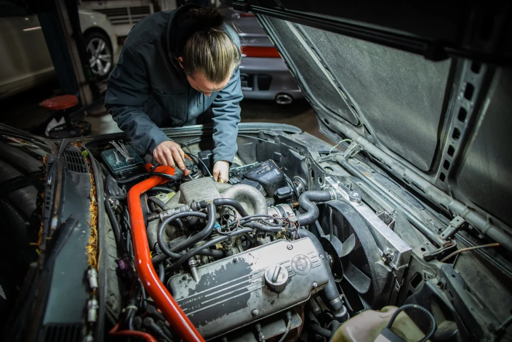Mechanic inspecting used BMW engine bay