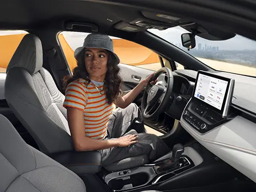 Toyota Corolla Hybrid exterior and interior showcasing affordable hybrid design