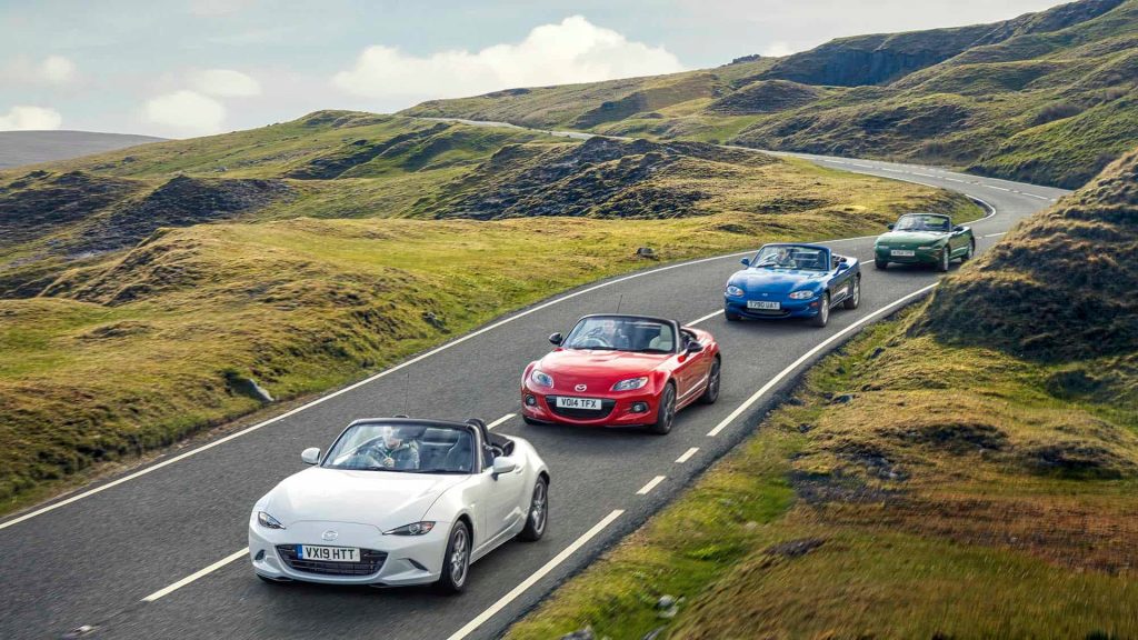 Affordable manual sports cars driving on scenic roads.