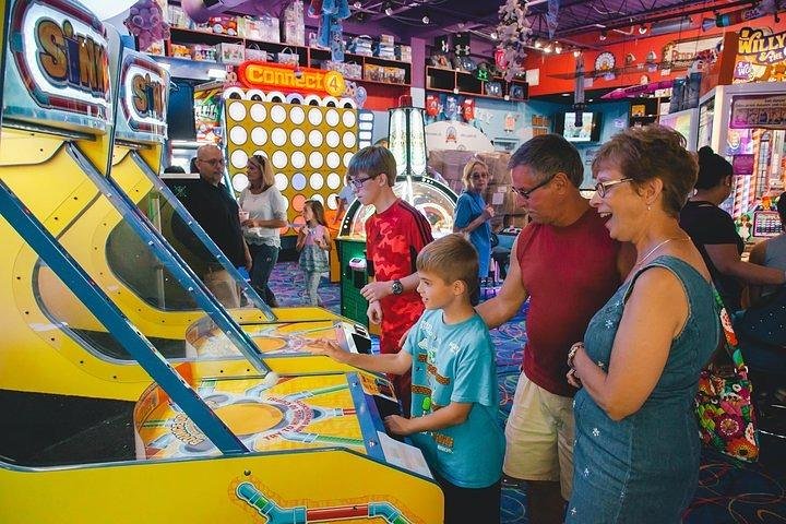 Family enjoying arcade games at an indoor entertainment center in Pigeon Forge
