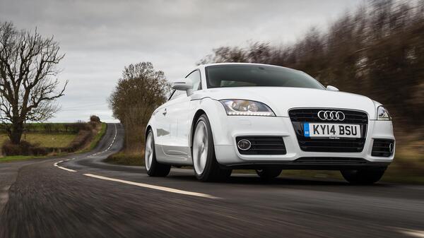 Happy driver enjoying an affordable manual transmission car.
