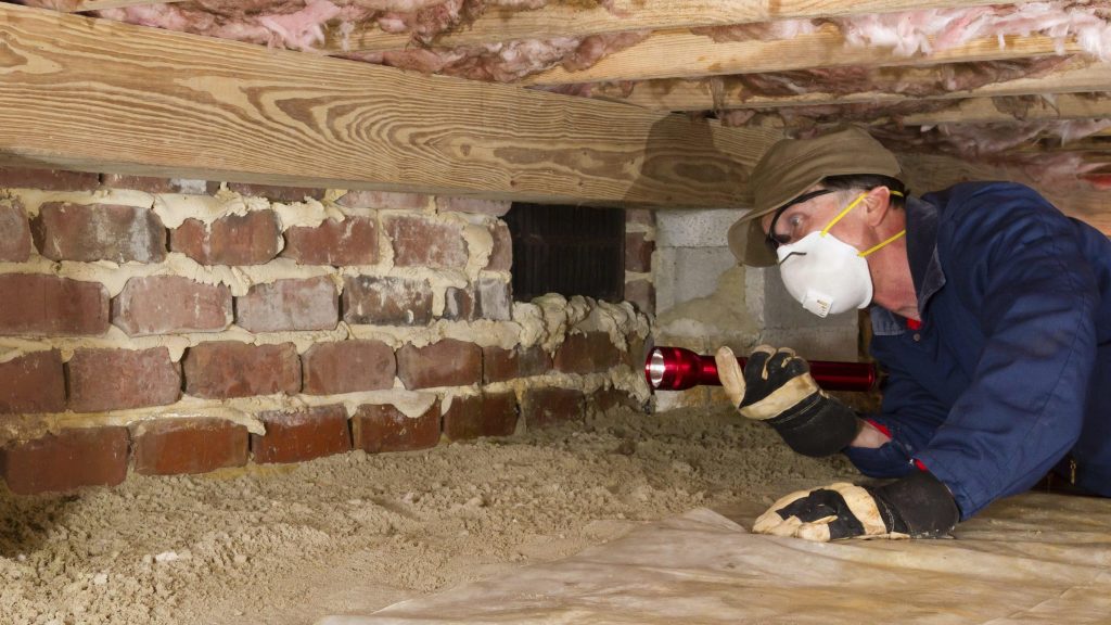 Homeowner preparing attic space for insulation installation