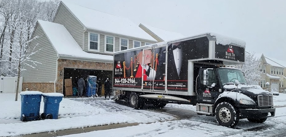 Moving truck outside apartment building during winter