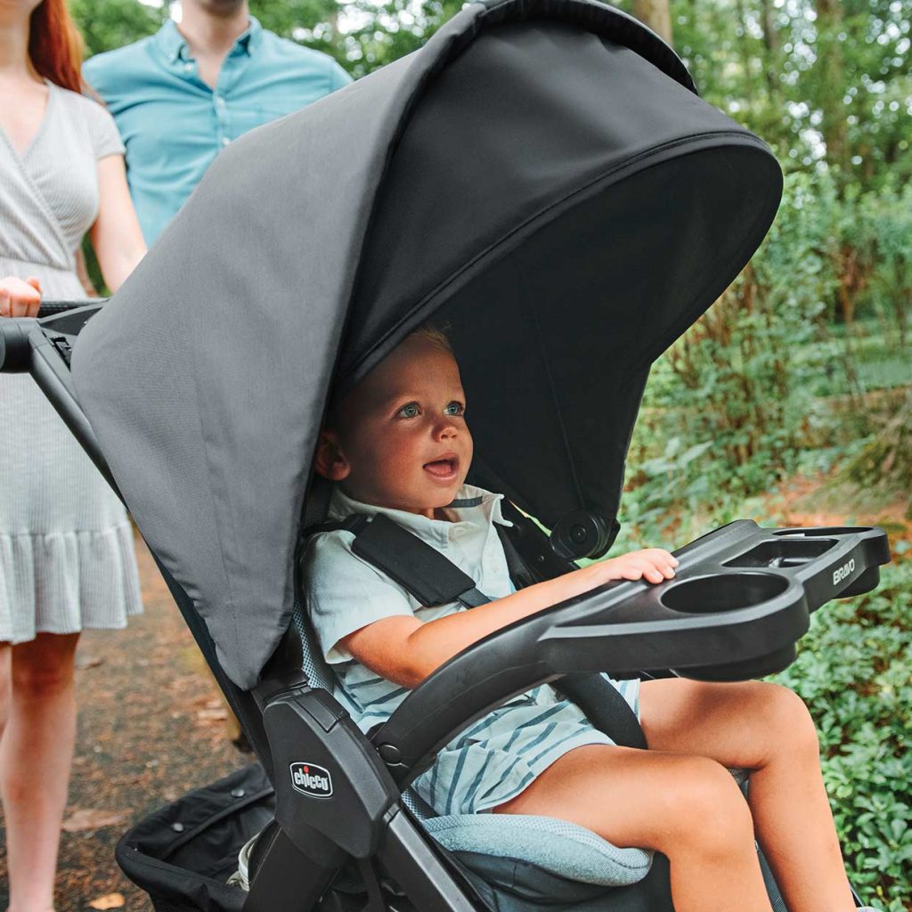 Parent examining different strollers in a store