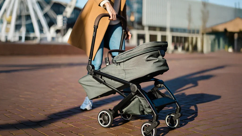 Parent folding a budget-friendly stroller for storage