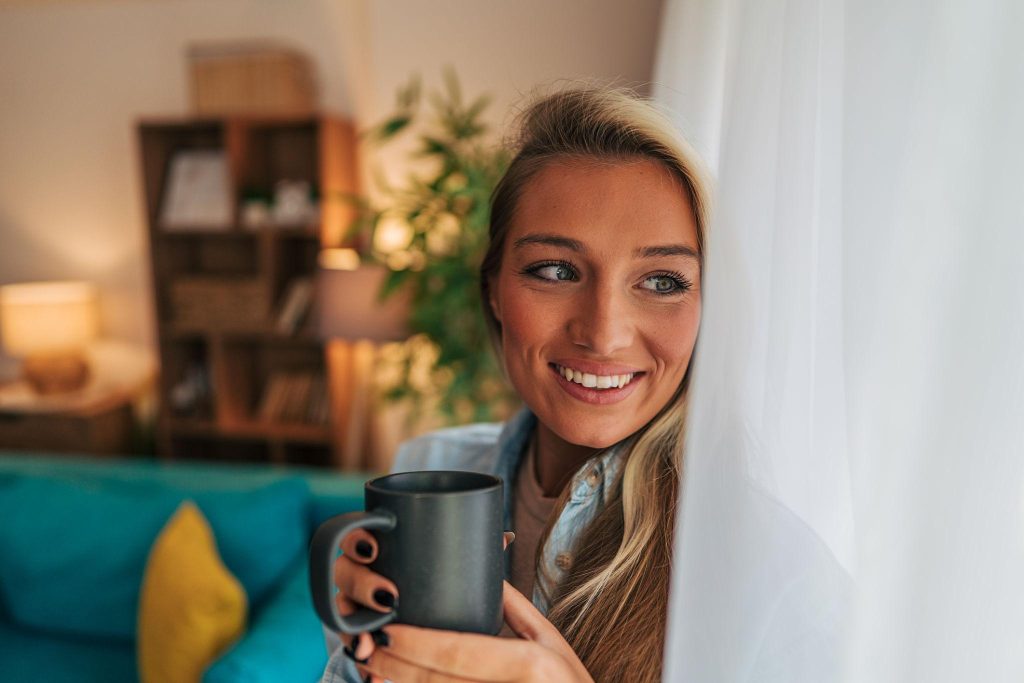 Person enjoying coffee at home in the morning