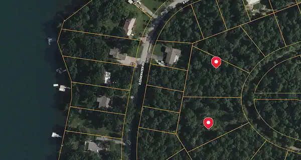 Person searching for cheap land in Arkansas using online real estate platforms