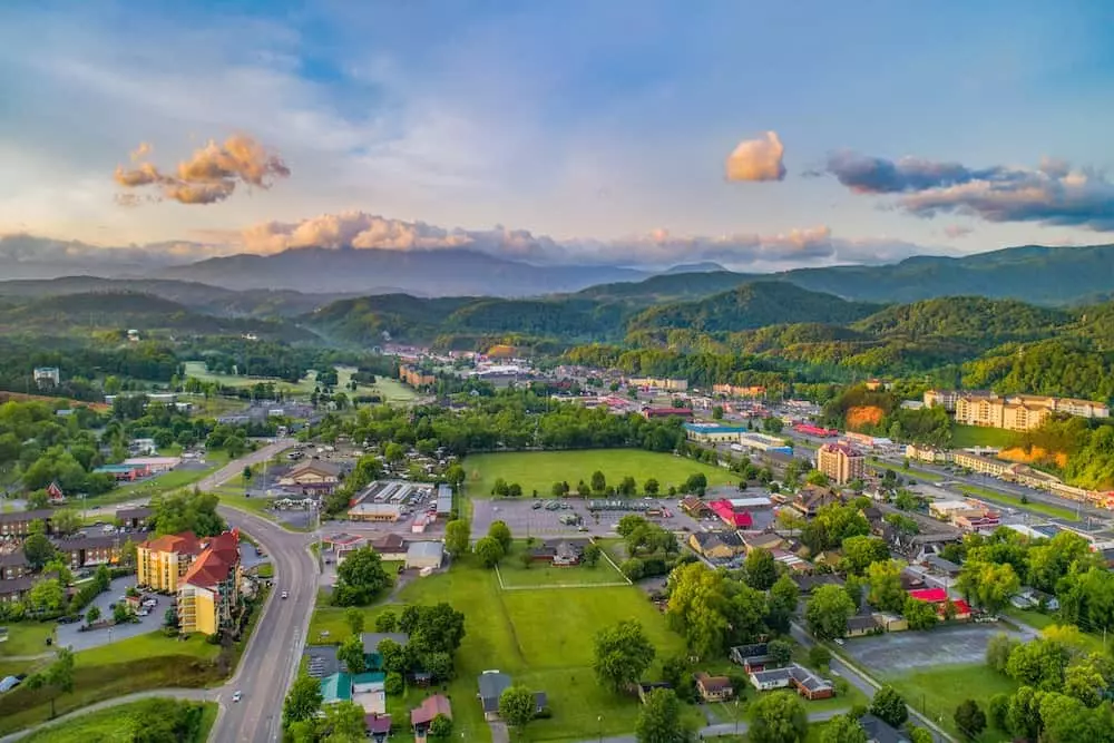 Tourists walking along the lively Pigeon Forge Parkway with attractions and shops