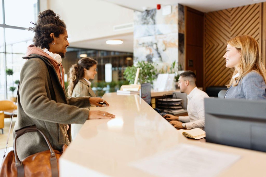 Traveler researching cheap hotel questions and booking tips on a phone