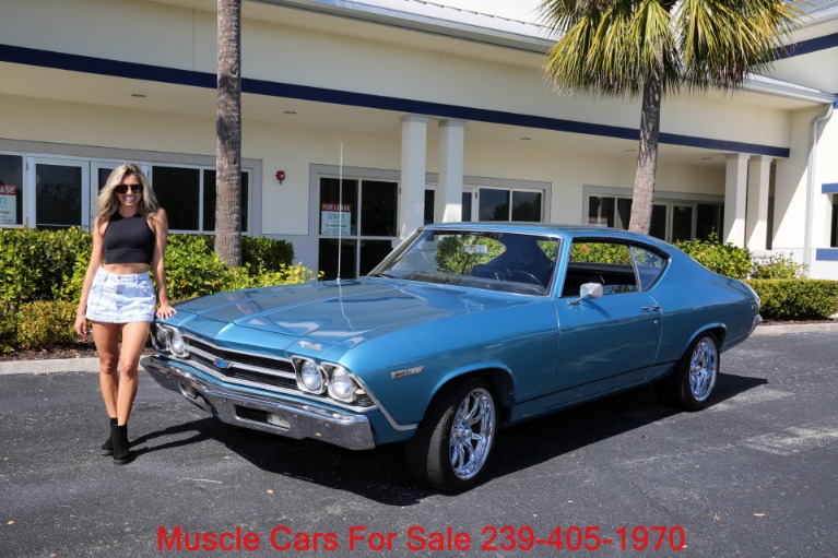 Used car dealership lot with muscle cars