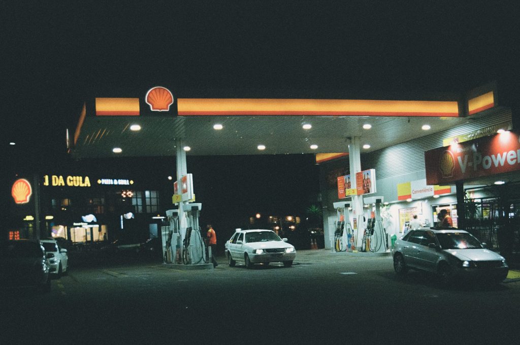 V8 muscle car refueling at a gas station in the United States