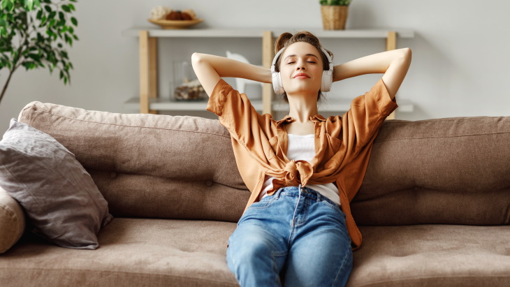 Young professional relaxing in cozy studio apartment