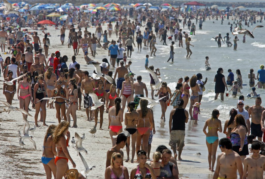 crowded spring break beach destination with expensive hotels and large tourist crowds