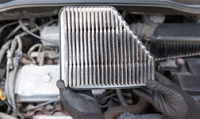 Mechanic holding dirty air filter