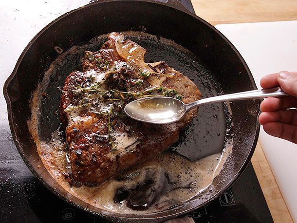 searing steak in cast iron skillet with butter